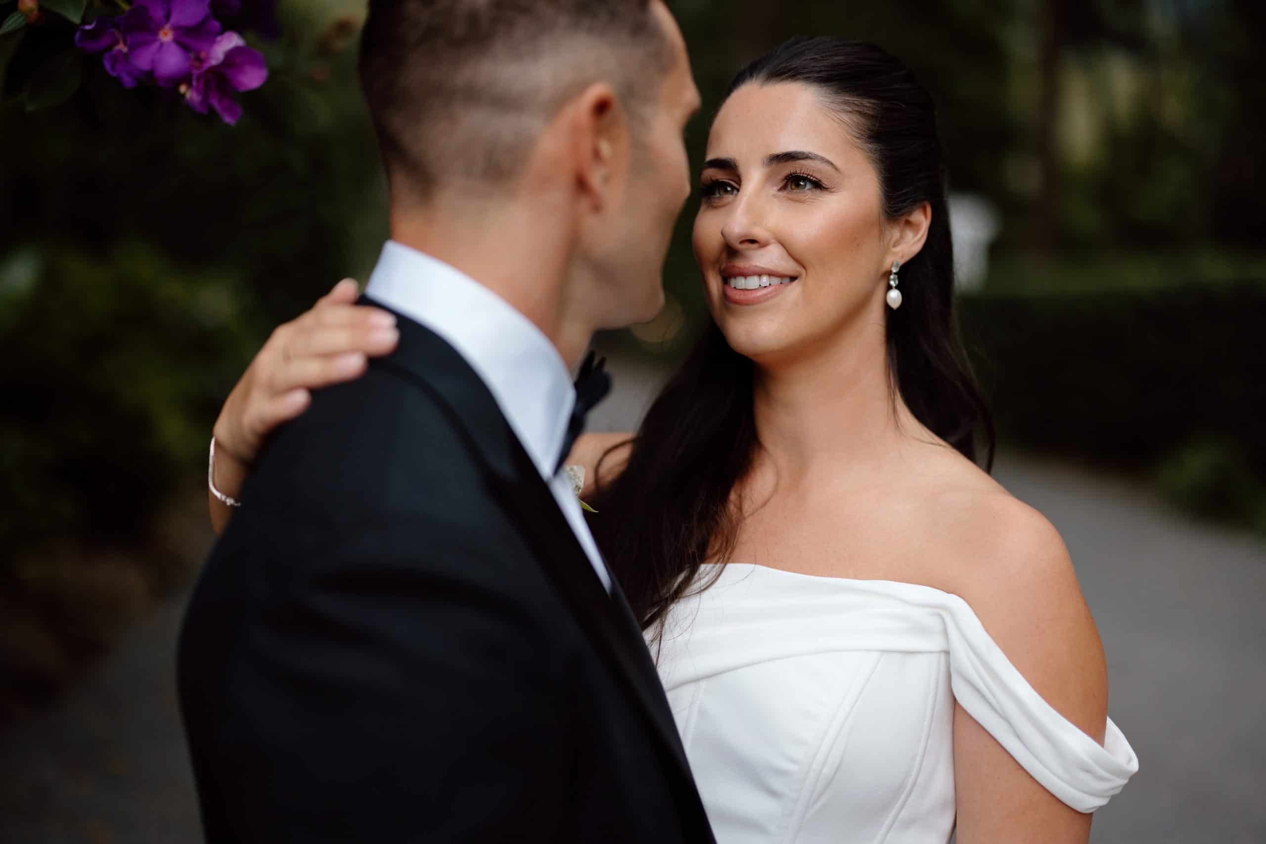 bride with natural makeup looking at her groom